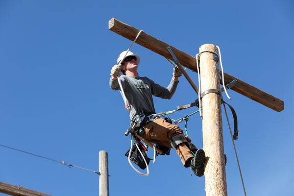 A lineman on a power pole.